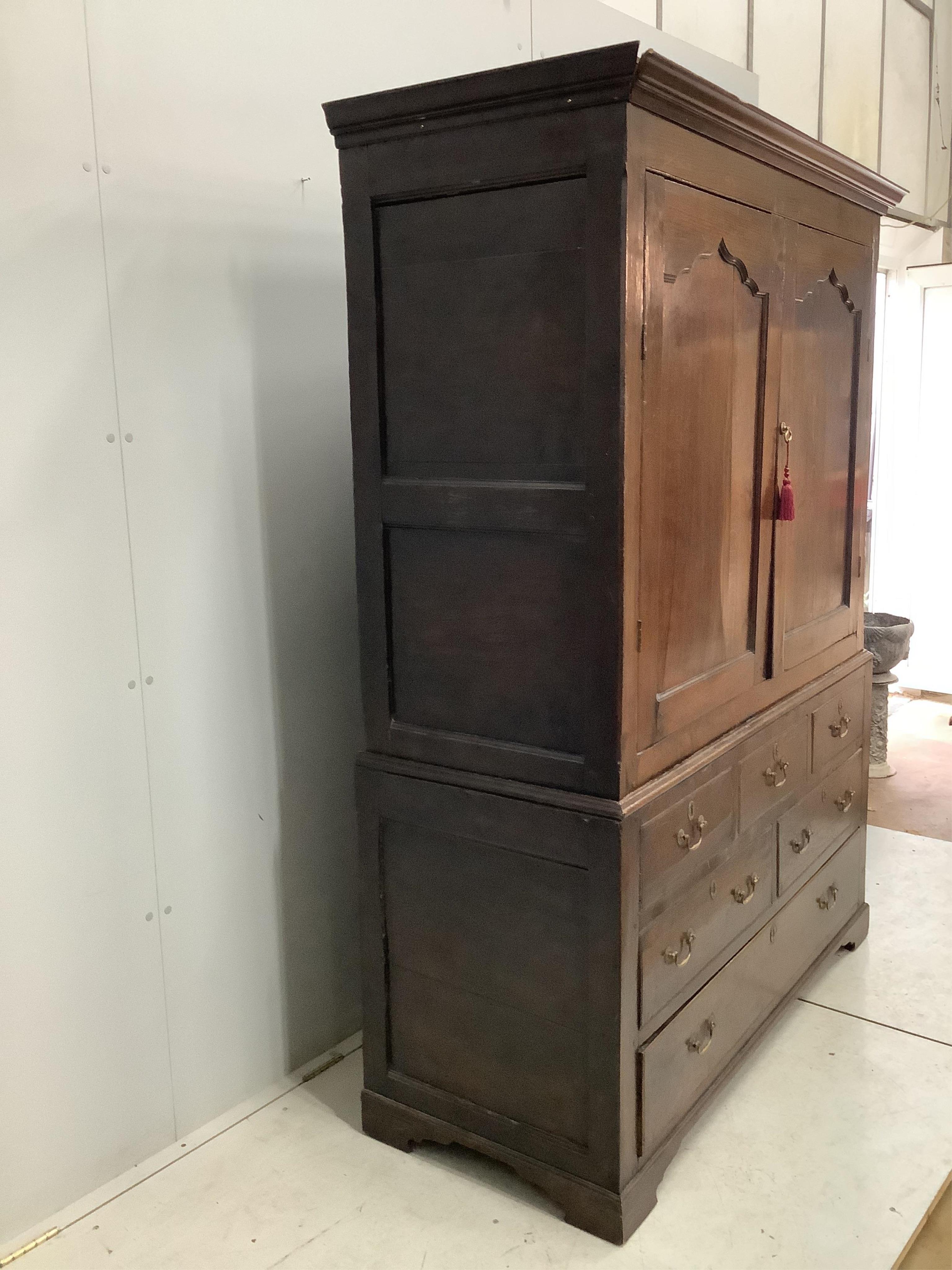 An early 18th century and later oak press cupboard with two doors and one base drawer, width 140cm, height 185cm. Condition - fair to good